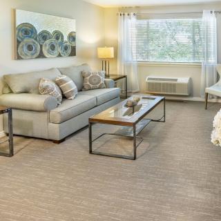 A cozy living room with a sofa, coffee table, and stylish decor.