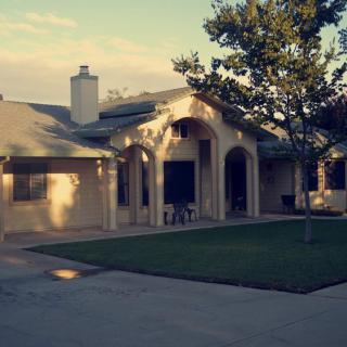 A suburban house with a well-maintained lawn and driveway.