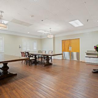 A spacious dining area featuring elegant wooden furniture and ample natural light.