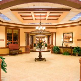 A spacious hotel lobby with elegant furnishings and warm lighting.