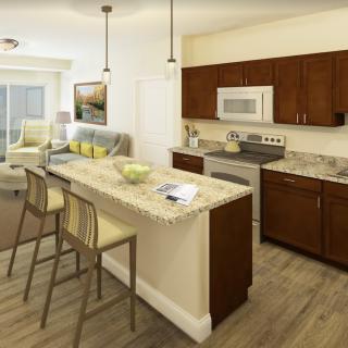 A modern open floor plan kitchen and living room with wooden flooring and contemporary furnishings.
