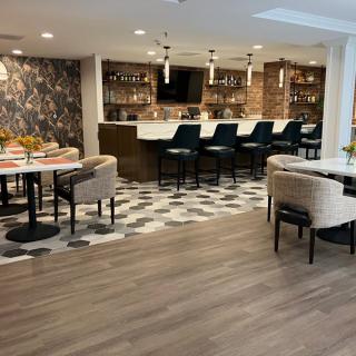 A modern restaurant interior featuring a stylish bar and comfortable seating areas.