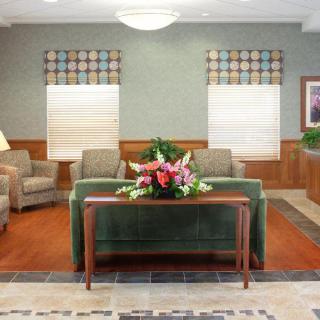 A welcoming lobby with comfortable seating and a table with a floral arrangement.