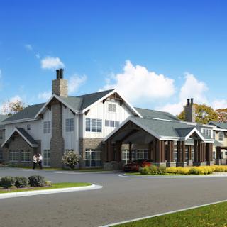 A modern residential building with a welcoming entrance and landscaped surroundings.