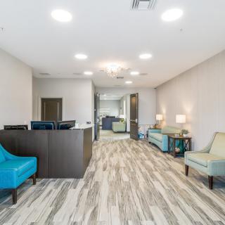 A modern waiting room with comfortable seating and elegant interior design.