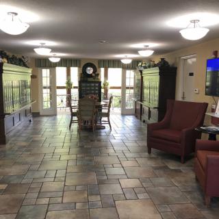 A cozy interior with seating arrangements and large aquariums lining the walls.