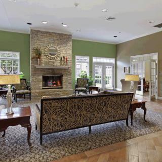 A cozy living room with a fireplace and stylish furniture.