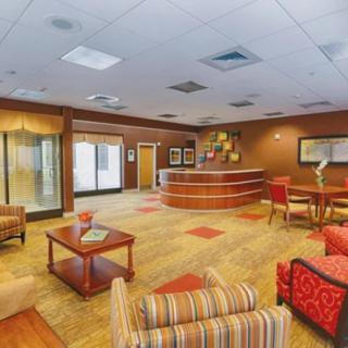 A modern lobby area featuring comfortable seating and a reception desk.