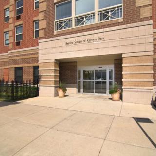 Entrance to an urban residential building with glass doors.