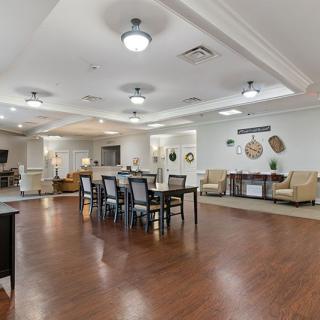Spacious and well-lit interior living space with a combined dining area, featuring elegant furniture and decor.