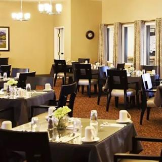 A neatly arranged dining room with tables set for a meal.