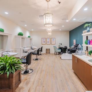 A modern and stylish hair salon featuring elegant lighting and contemporary decor.