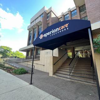 Entrance of a building with a blue canopy.