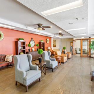 A cozy lounge area with comfortable seating and bright decor.