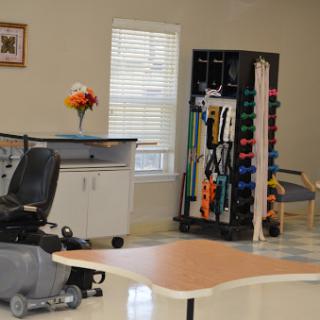A therapy room equipped with rehabilitation tools and a mobility aid, designed for physical recovery.