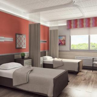 A modern hospital room with twin beds and natural light.