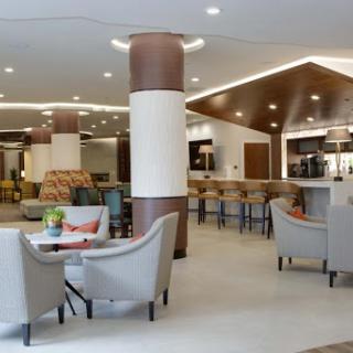A modern hotel lobby featuring a stylish seating area and contemporary design.