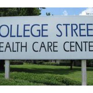A sign for College Street Health Care Center outdoors.