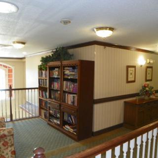 A cozy hallway with bookshelves and comfortable seating.