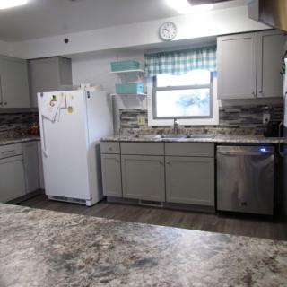 A kitchen interior featuring appliances and cabinetry.