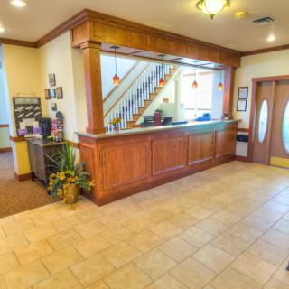 A hotel lobby with a reception desk and entrance area.