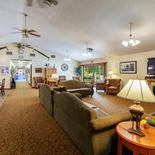 A spacious living room with comfortable seating, warm lighting, and a cozy atmosphere.