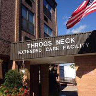 Entrance to Throgs Neck Extended Care Facility with an American flag.