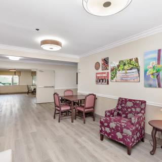 A spacious lobby area featuring seating arrangements with decorative artwork and lighting.