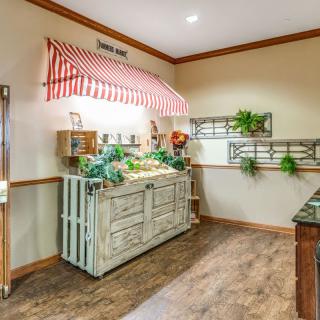 A rustic kitchen interior featuring a countertop with plants and decorative accents.