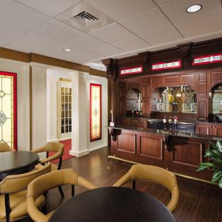 An elegant bar area featuring wooden furniture and cozy seating arrangements.