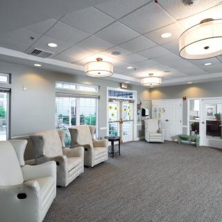 A modern and spacious waiting room with comfortable seating and elegant lighting.