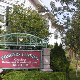 Sign for Edmonds Landing, a retirement and assisted living community, surrounded by greenery.