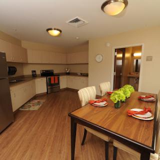 A spacious and modern kitchen with an inviting dining area, featuring a stylish table setting.
