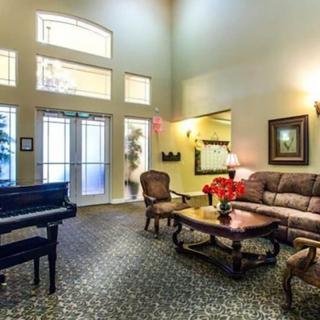 A welcoming lobby area featuring a grand piano, comfortable seating, and elegant decor.