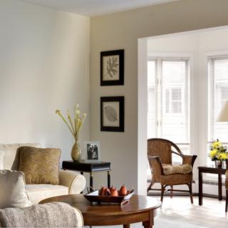A cozy and elegantly designed living room with comfortable seating and natural light.