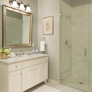 A modern bathroom with a glass-enclosed shower and elegant vanity.