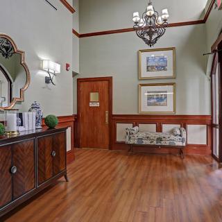 A well-appointed lobby with elegant decor and wood flooring.