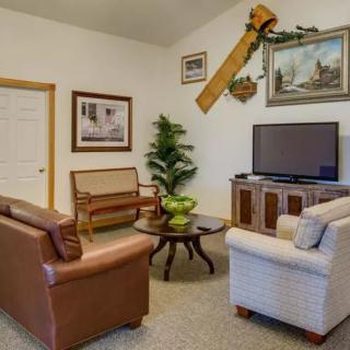 A cozy living room with comfortable seating, a television, and decorative elements.
