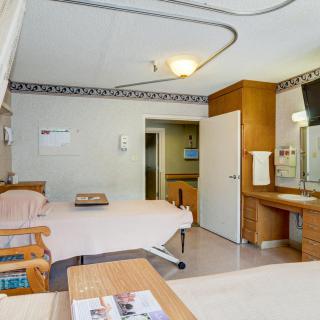 Clean and well-equipped hospital room with beds and medical facilities.