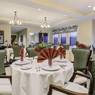 Elegant dining room with neatly arranged tables and decorative napkins.