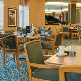 A cozy cafe interior with neatly arranged tables and chairs, creating a welcoming and relaxing atmosphere.