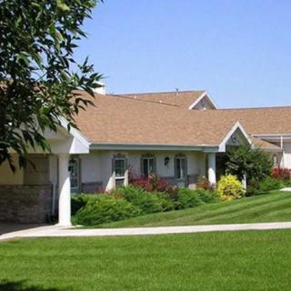 A suburban residential area with well-maintained lawns and modern houses.