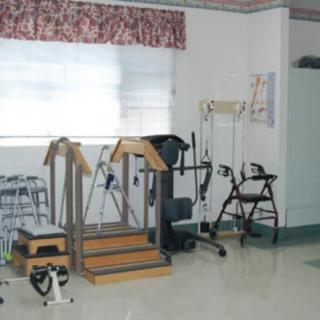 A room equipped with various rehabilitation and physical therapy devices.