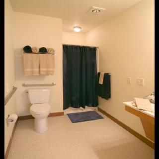 A minimalist bathroom with essential amenities and a tidy arrangement.