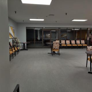A spacious and empty waiting room featuring modern seating arrangements and a well-lit environment.