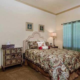 Cozy bedroom with elegant decor and patterned bedding.