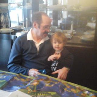 A heartwarming moment shared between a man and a child at a cafe.