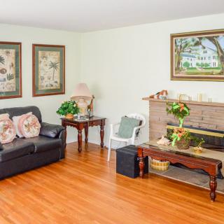 A cozy living room with a sofa, coffee table, and artwork on the walls.