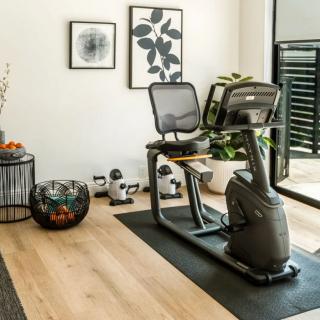 A modern home gym setup featuring a fitness bike and stylish decor.