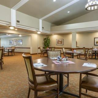 A spacious dining room with neatly arranged tables and chairs.